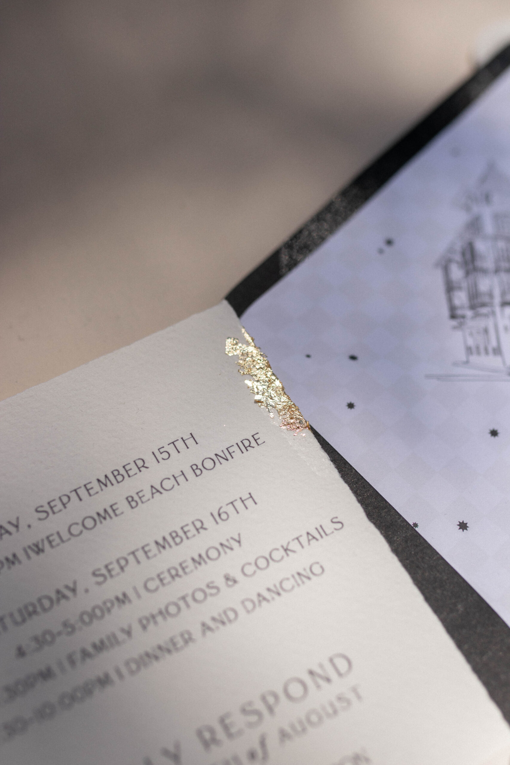 Deckled-edge paper and gold leaf wedding invitation