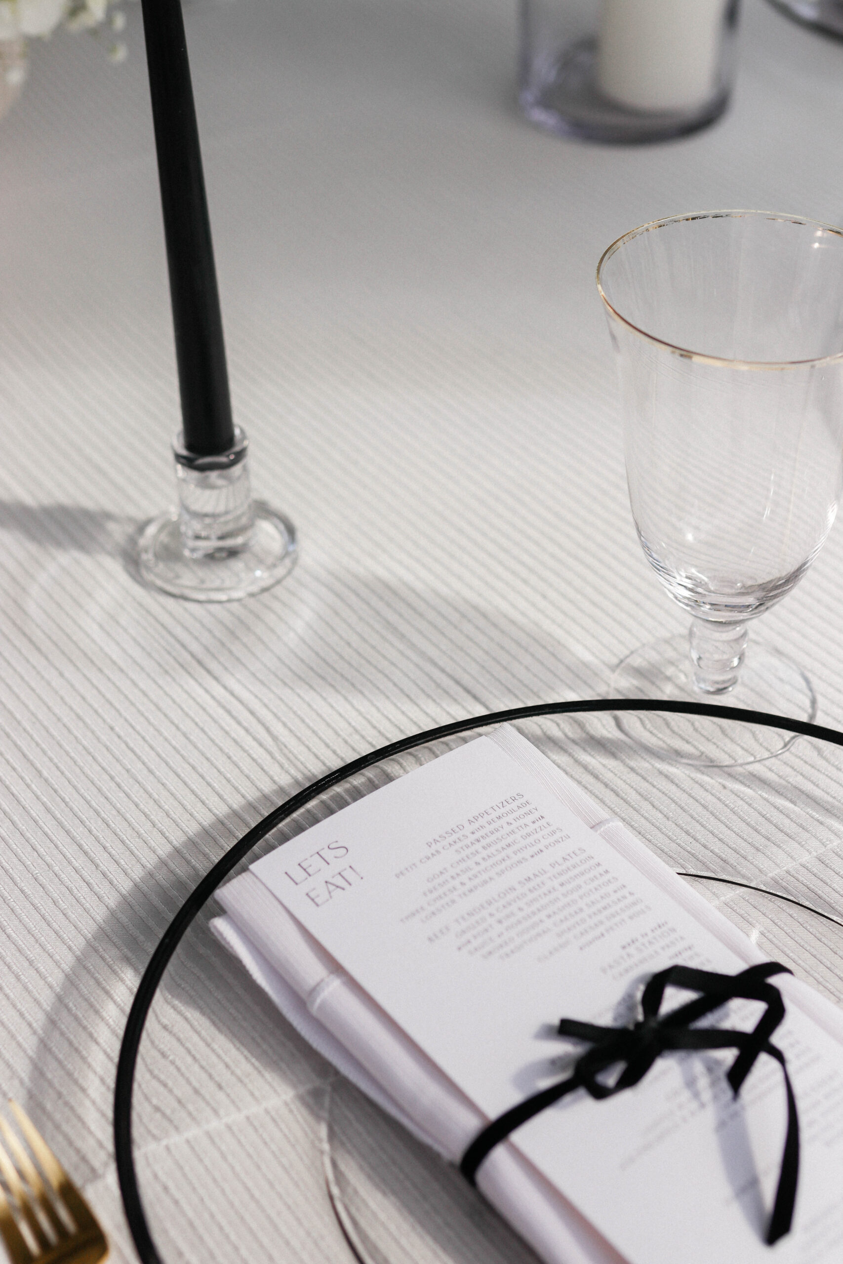 Black and white menu tied with velvet cord