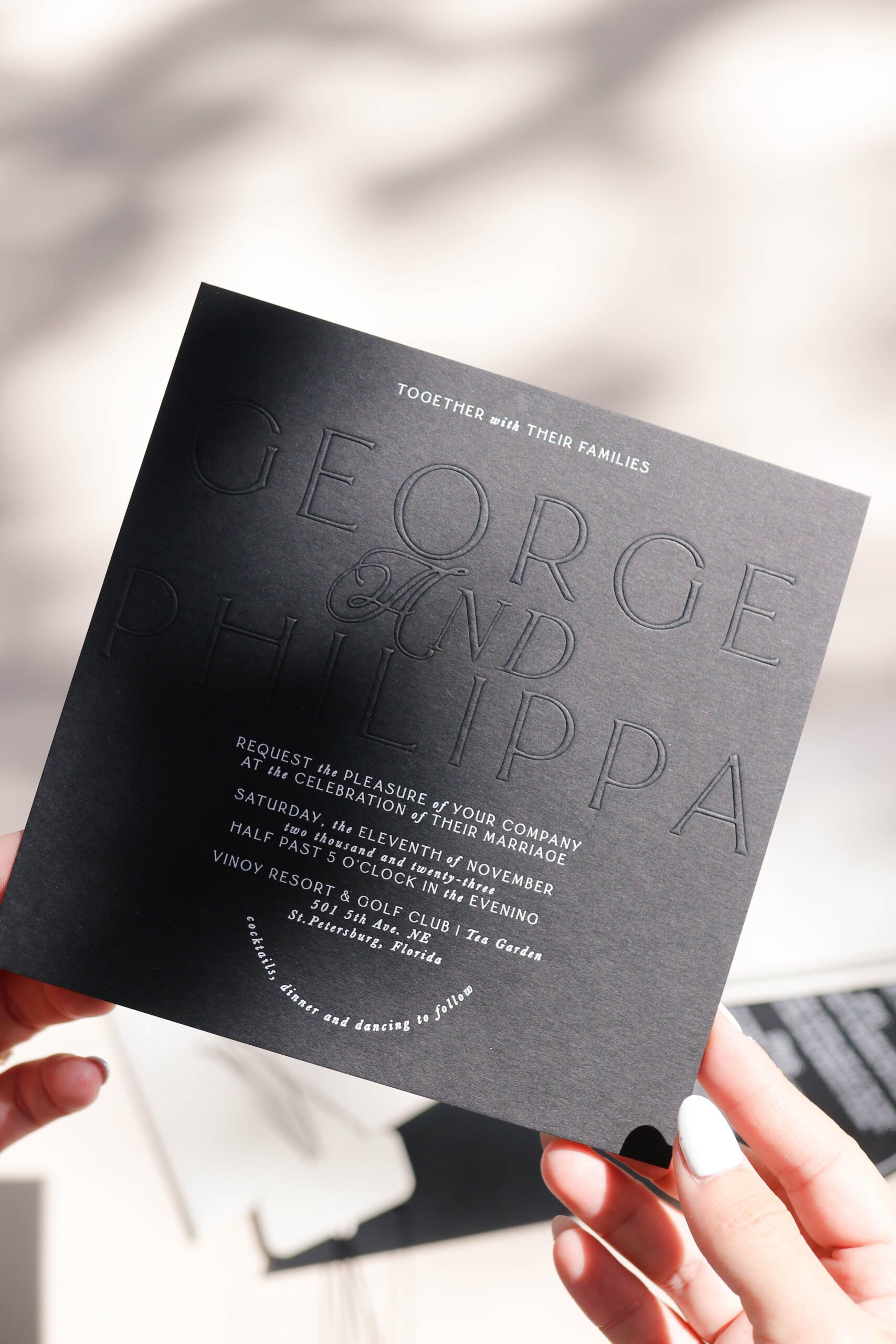 black debossed and embossed wedding invitation with white foil print